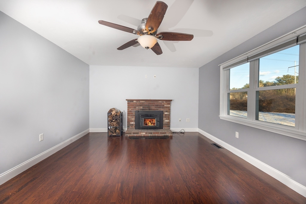 345 Cross Street Bridgewater, MA 02324 - Photo 6 of 27 a living room with furniture and a fireplace