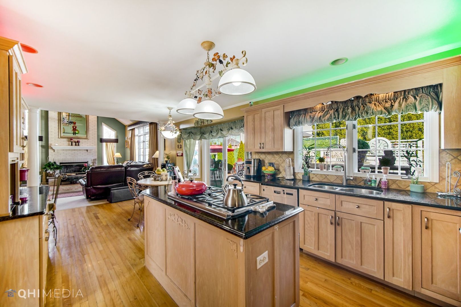 13243 Sunderlin Road Plainfield, IL 60585 - Photo 16 of 40 a kitchen with kitchen island granite countertop a sink cabinets and window