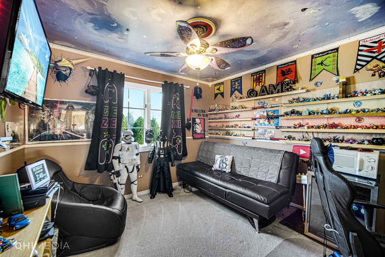 13243 Sunderlin Road Plainfield, IL 60585 - Photo 22 of 40 a living room with furniture a flat screen tv and a floor to ceiling window