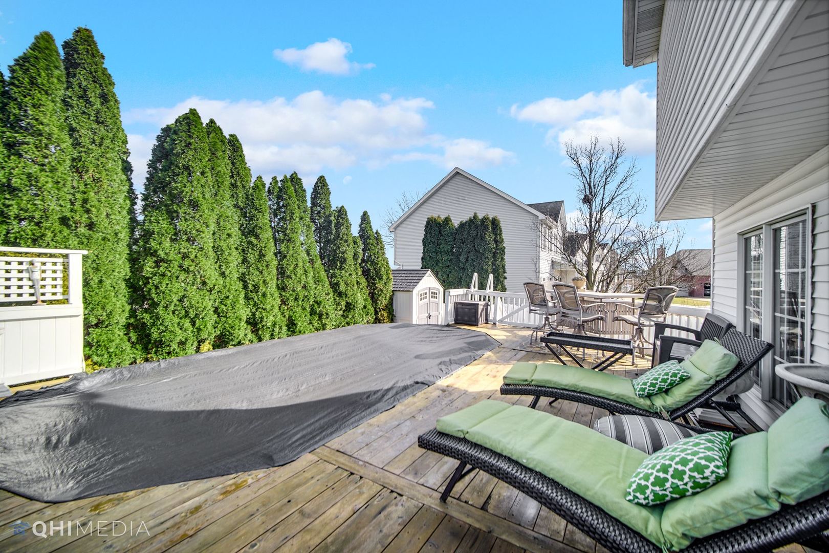 13243 Sunderlin Road Plainfield, IL 60585 - Photo 40 of 40 a view of a patio with couches table and chairs with wooden floor and fence