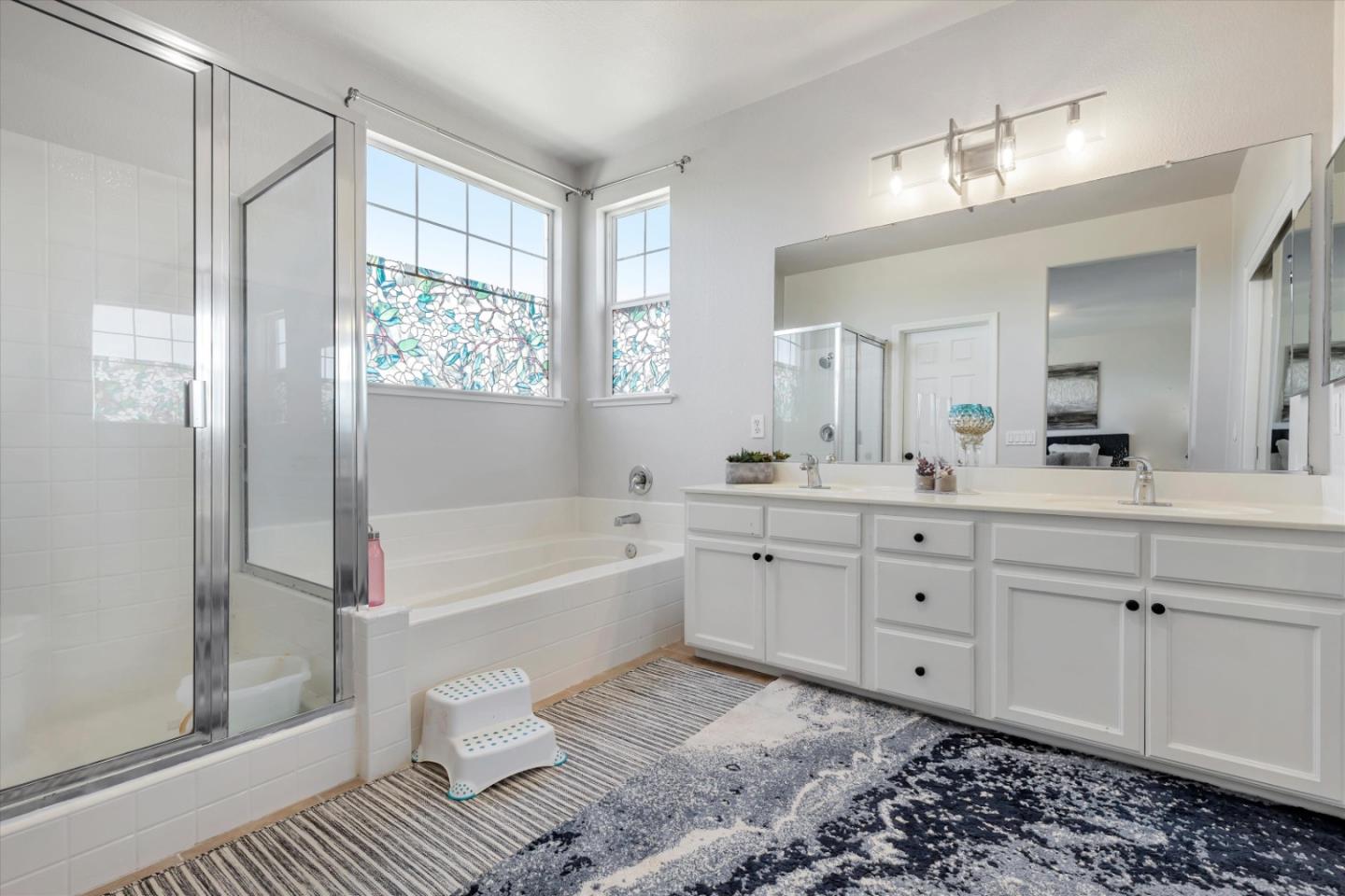 252 Comeabout Circle Pittsburg, CA 94565 - Photo 19 of 41 a spacious bathroom with a double vanity sink a mirror and a bathtub