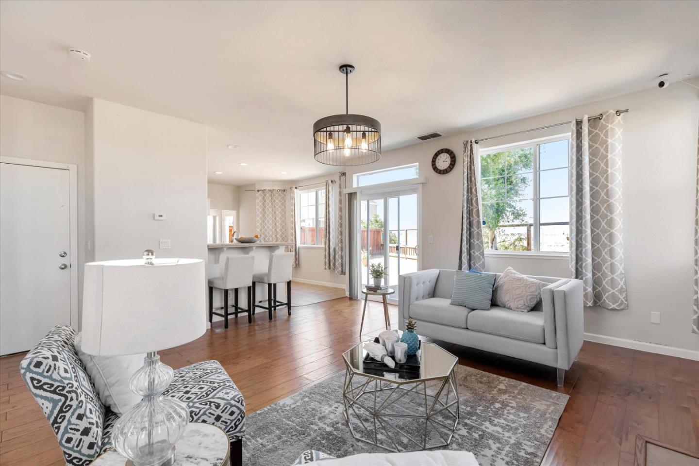 252 Comeabout Circle Pittsburg, CA 94565 - Photo 7 of 41 a living room with furniture a dining table and a chandelier