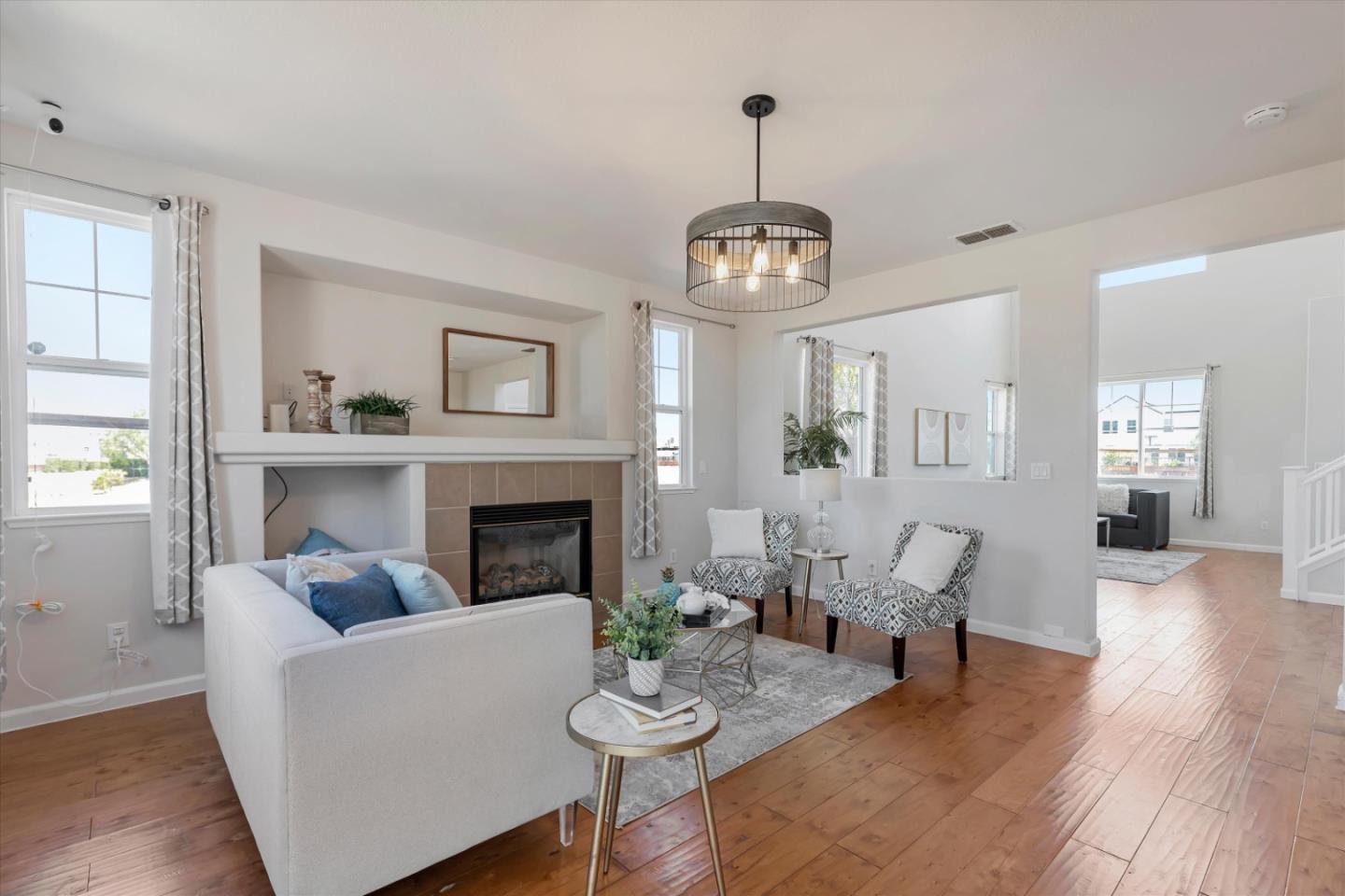 252 Comeabout Circle Pittsburg, CA 94565 - Photo 9 of 41 a living room with furniture a fireplace and a chandelier