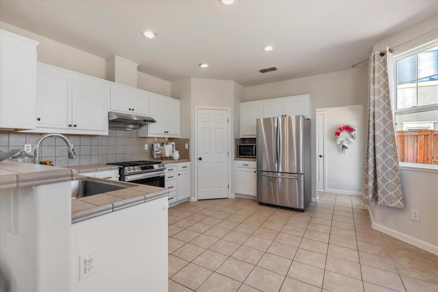 252 Comeabout Circle Pittsburg, CA 94565 - Photo 10 of 41 a kitchen with stainless steel appliances granite countertop a refrigerator sink and stove