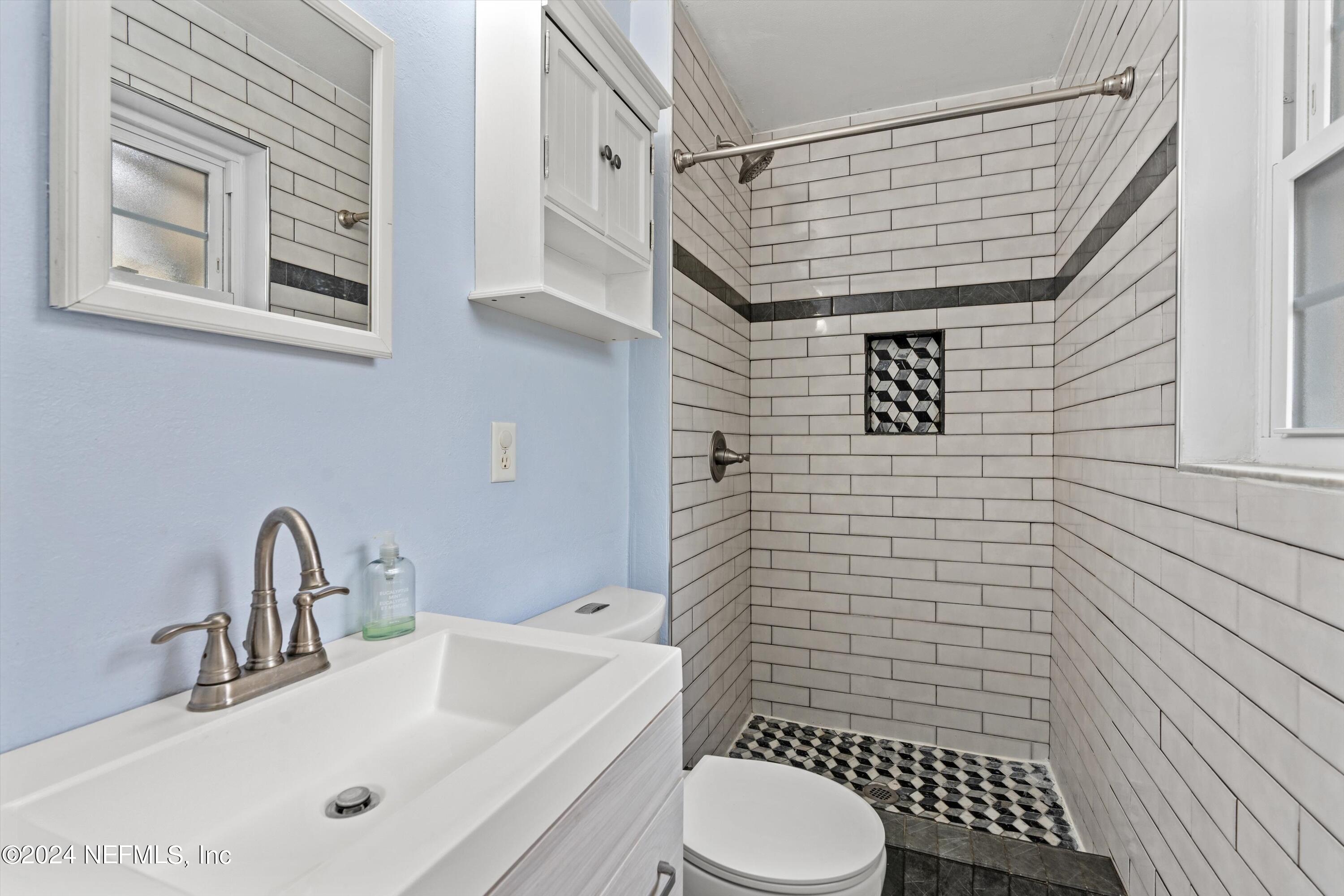 10750 Java Drive Jacksonville, FL 32246 - Photo 14 of 23 a bathroom with a sink toilet and shower