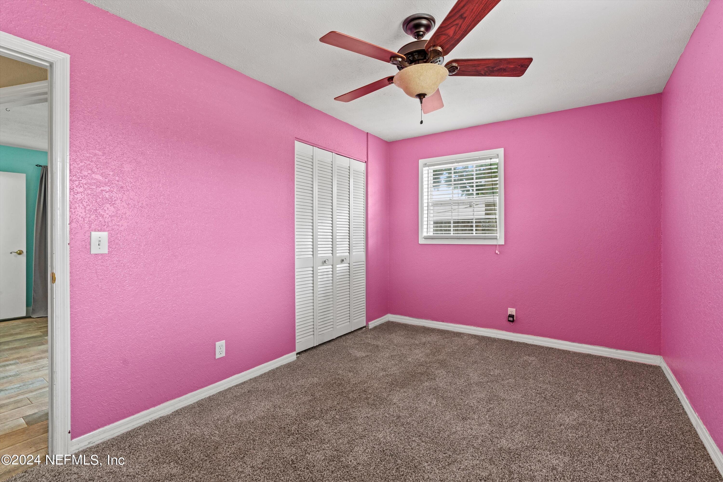 10750 Java Drive Jacksonville, FL 32246 - Photo 16 of 23 a view of a big room with wooden floor and a chandelier fan
