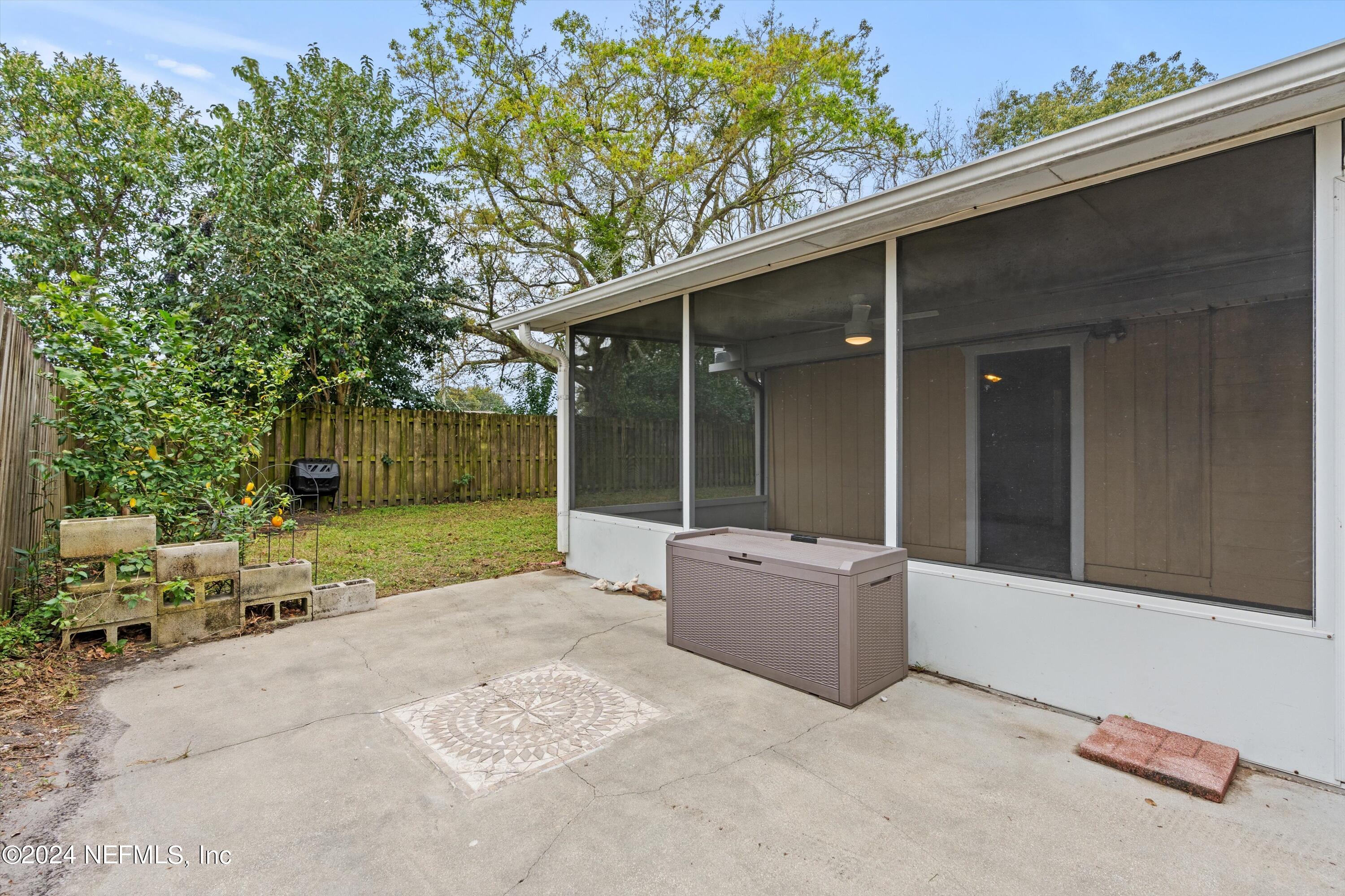 10750 Java Drive Jacksonville, FL 32246 - Photo 20 of 23 a view of backyard with outdoor seating and green space