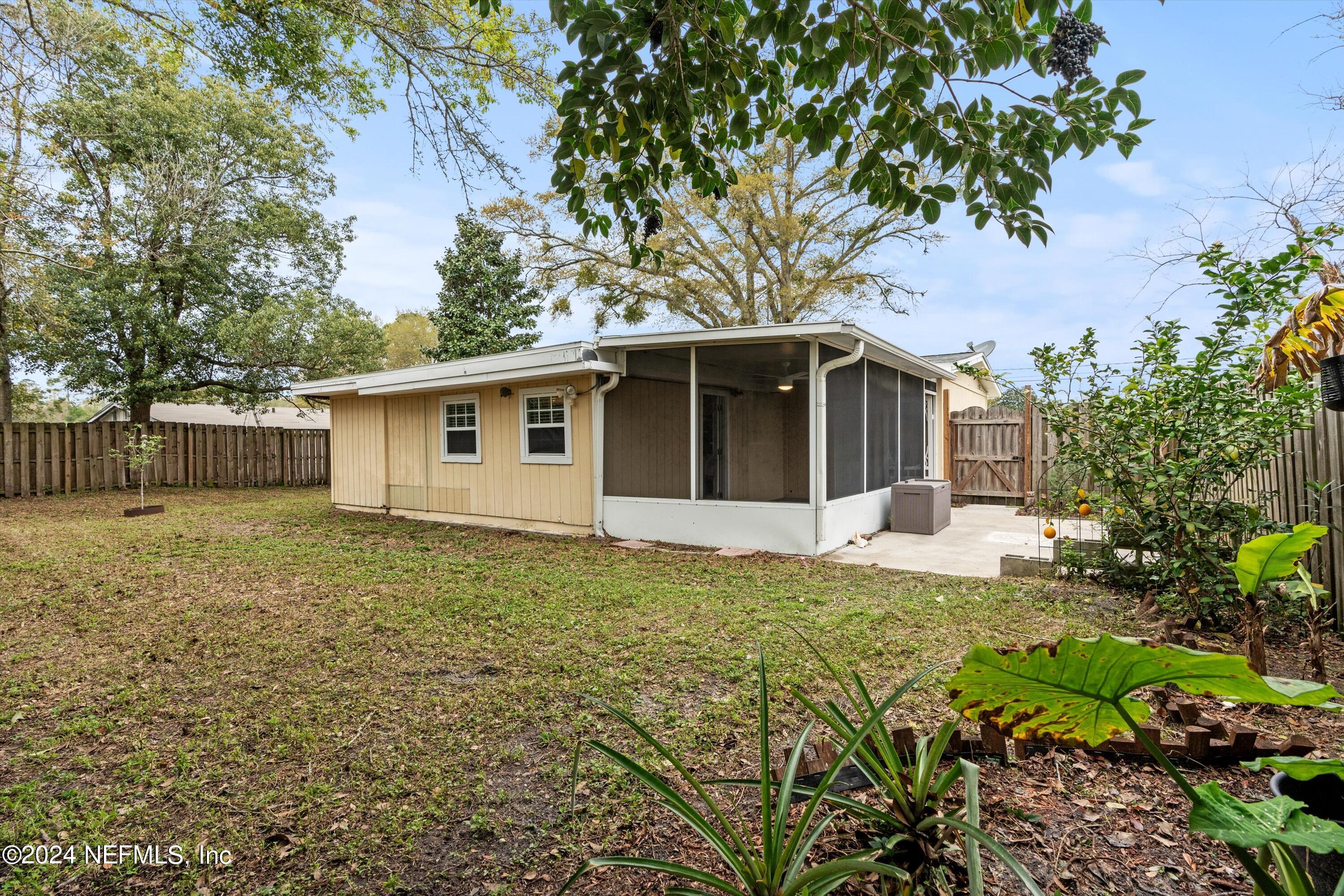 10750 Java Drive Jacksonville, FL 32246 - Photo 22 of 23 a front view of house with yard and green space