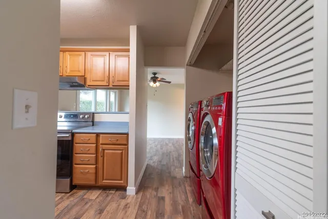 a view of walk in closet with wooden floor