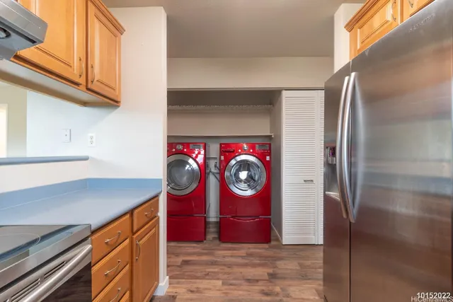 a view of a kitchen with stainless steel appliances granite countertop a refrigerator and a stove