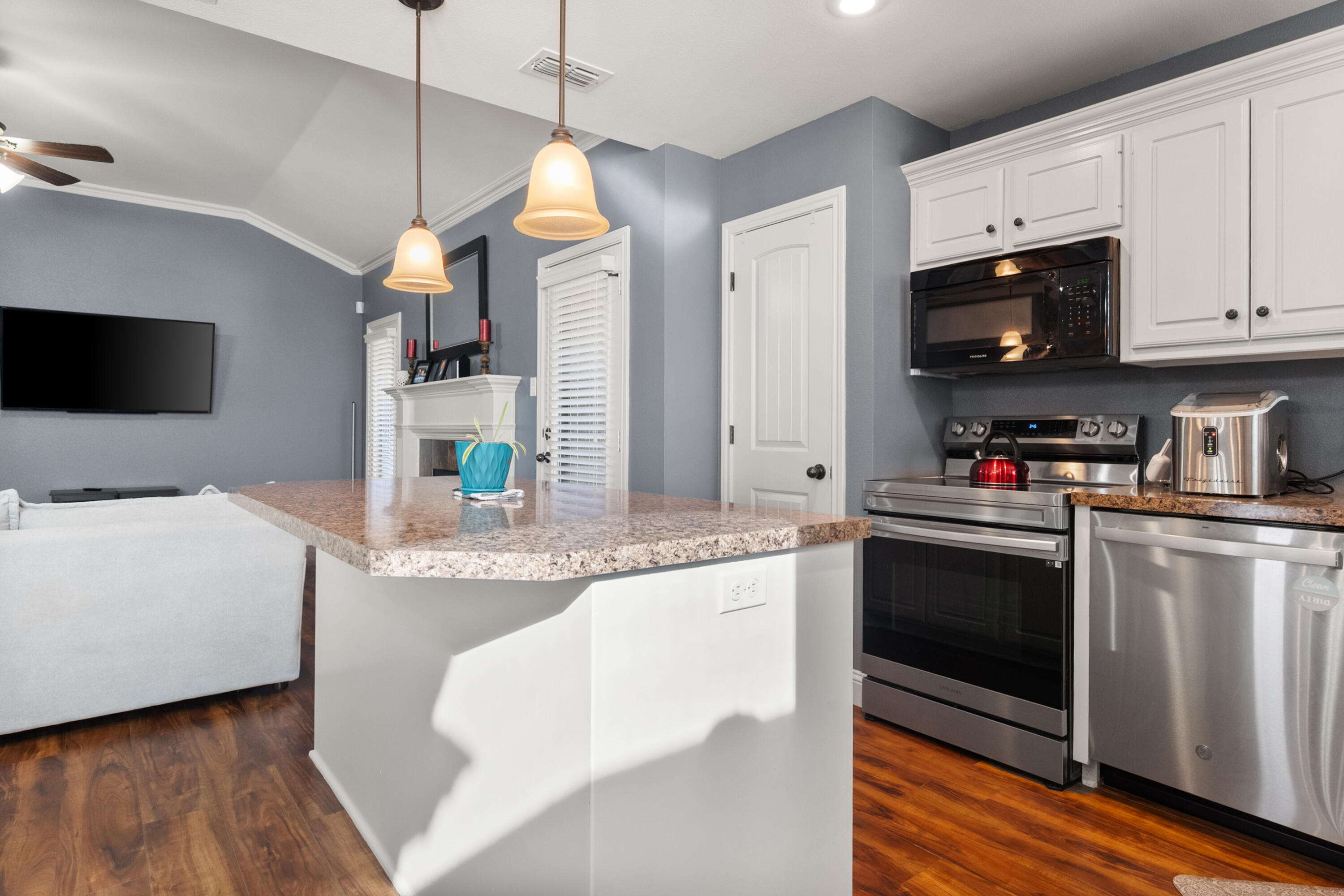 5908 104th Street Lubbock, TX 79424 - Photo 12 of 33 a kitchen with stainless steel appliances granite countertop a sink a stove and a refrigerator