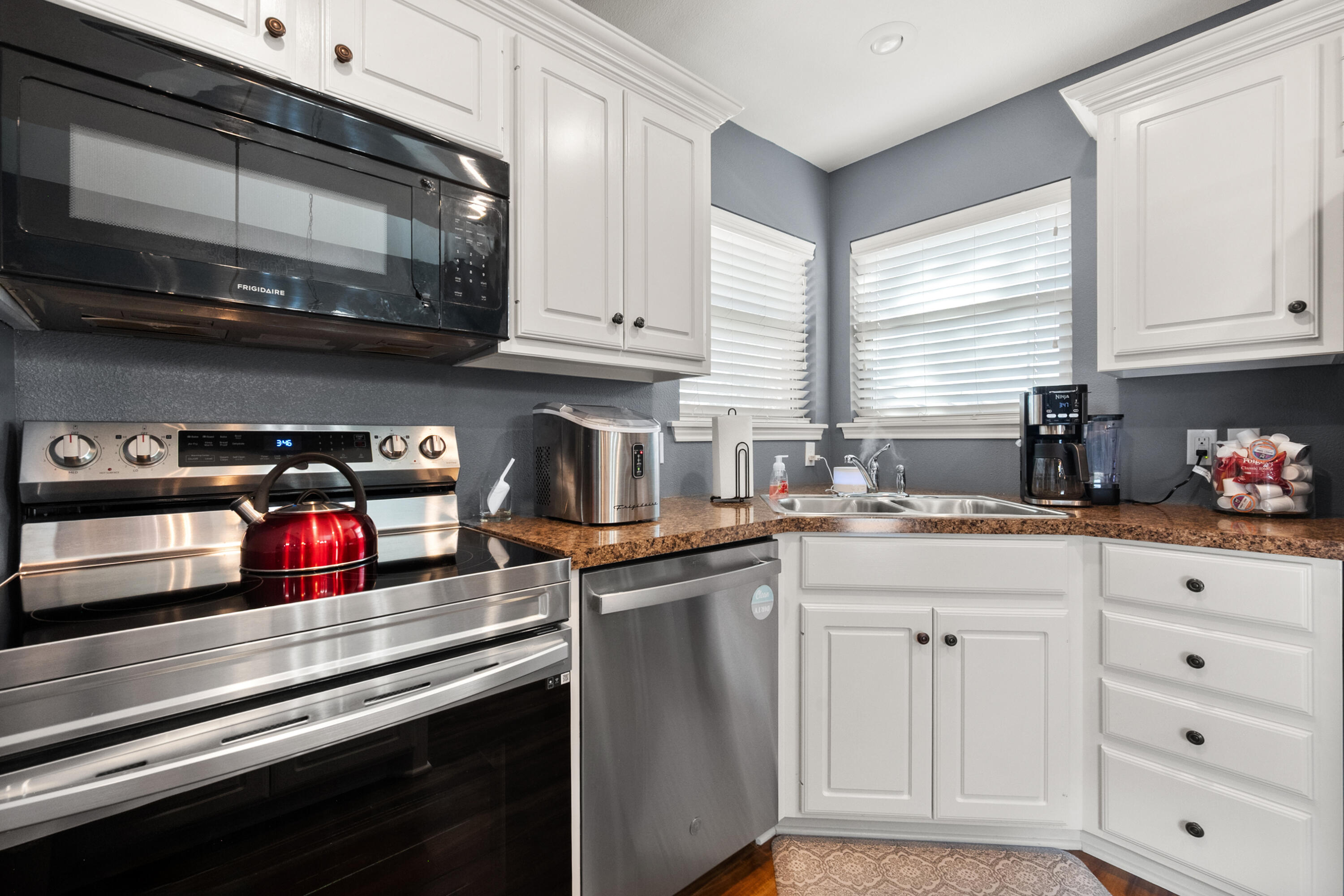 5908 104th Street Lubbock, TX 79424 - Photo 13 of 33 a kitchen with stainless steel appliances granite countertop a sink and cabinets