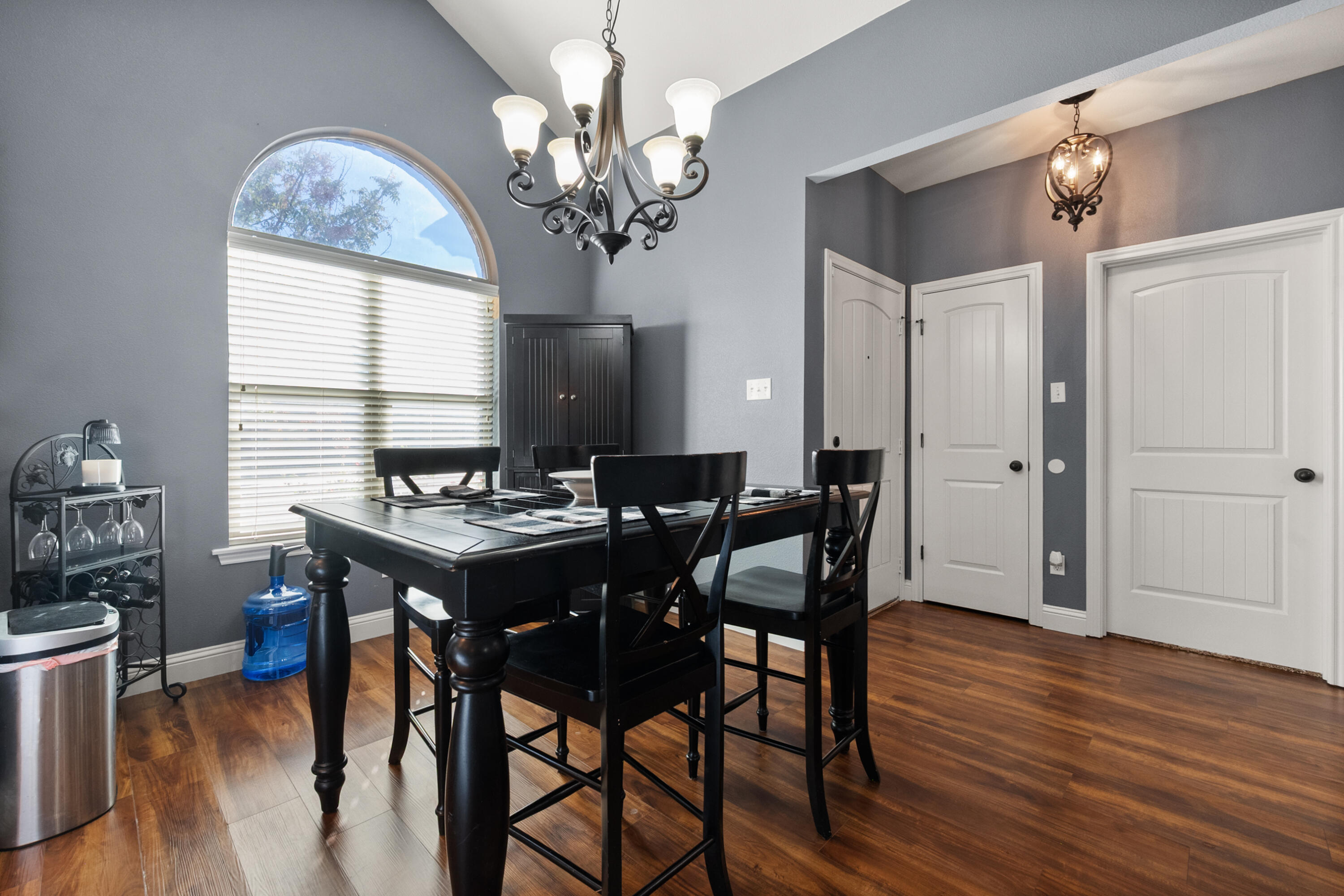5908 104th Street Lubbock, TX 79424 - Photo 14 of 33 a view of a dining room with furniture a chandelier and wooden floor