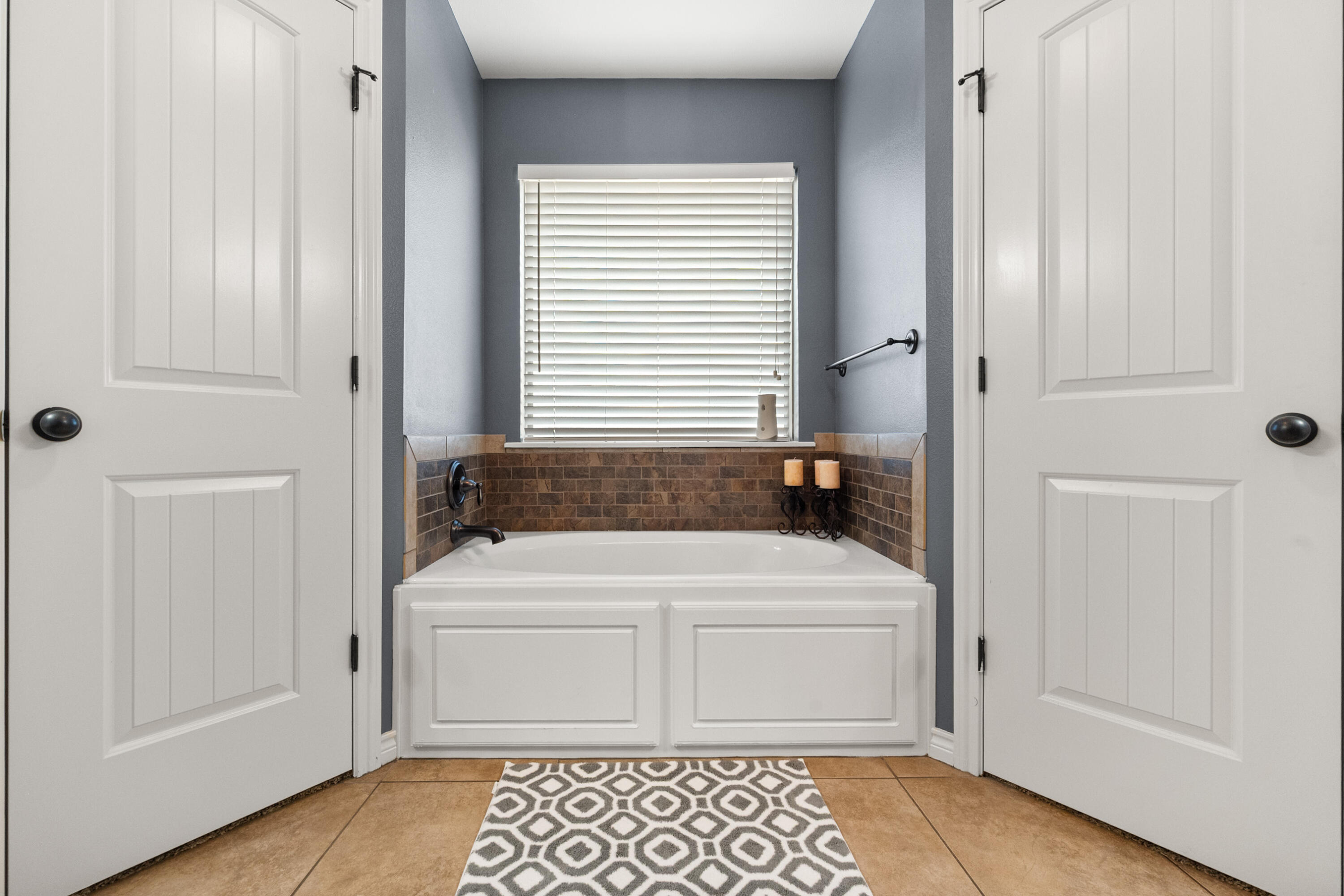 5908 104th Street Lubbock, TX 79424 - Photo 18 of 33 a bathroom with a sink a toilet and a window