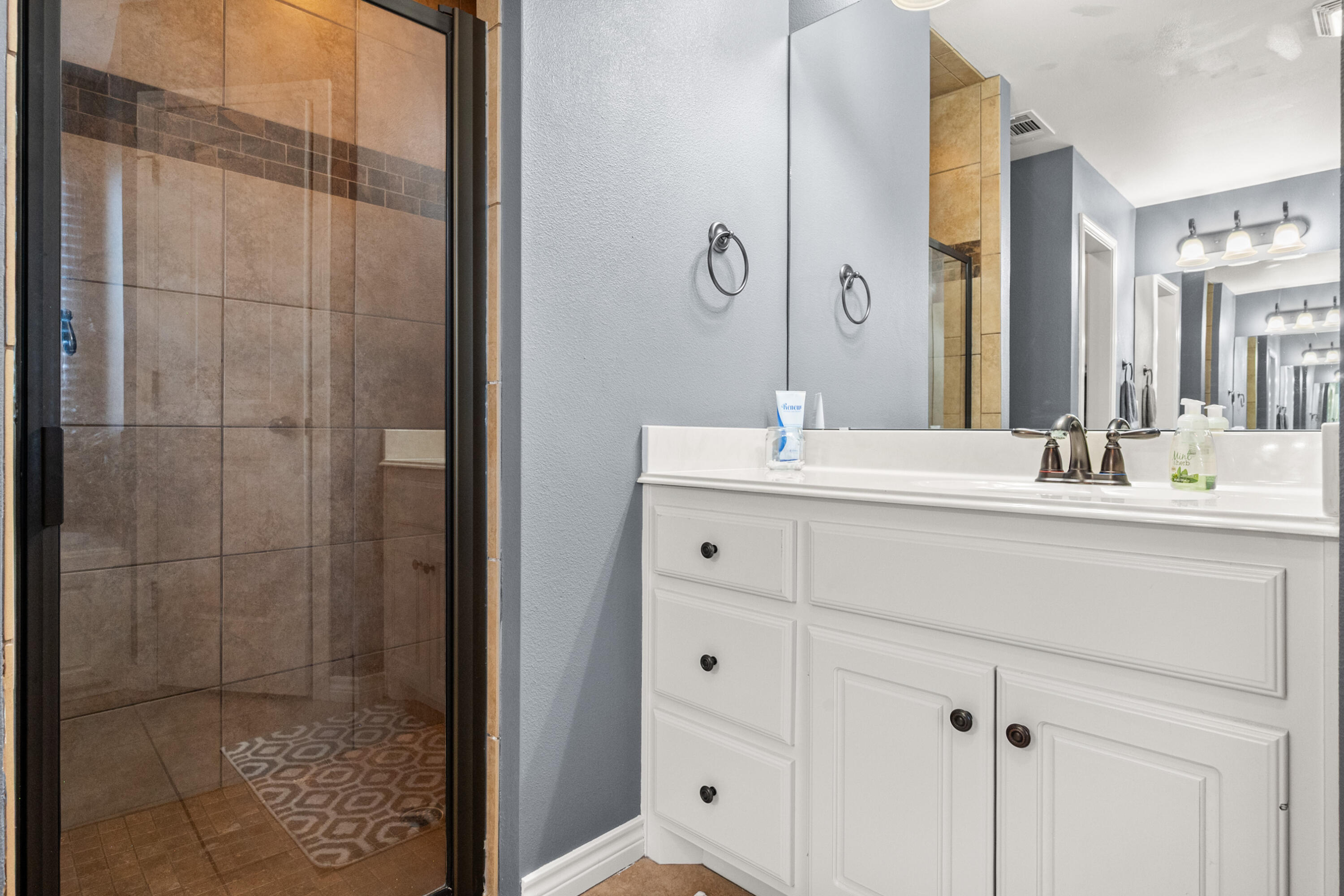 5908 104th Street Lubbock, TX 79424 - Photo 19 of 33 a bathroom with a sink and a mirror