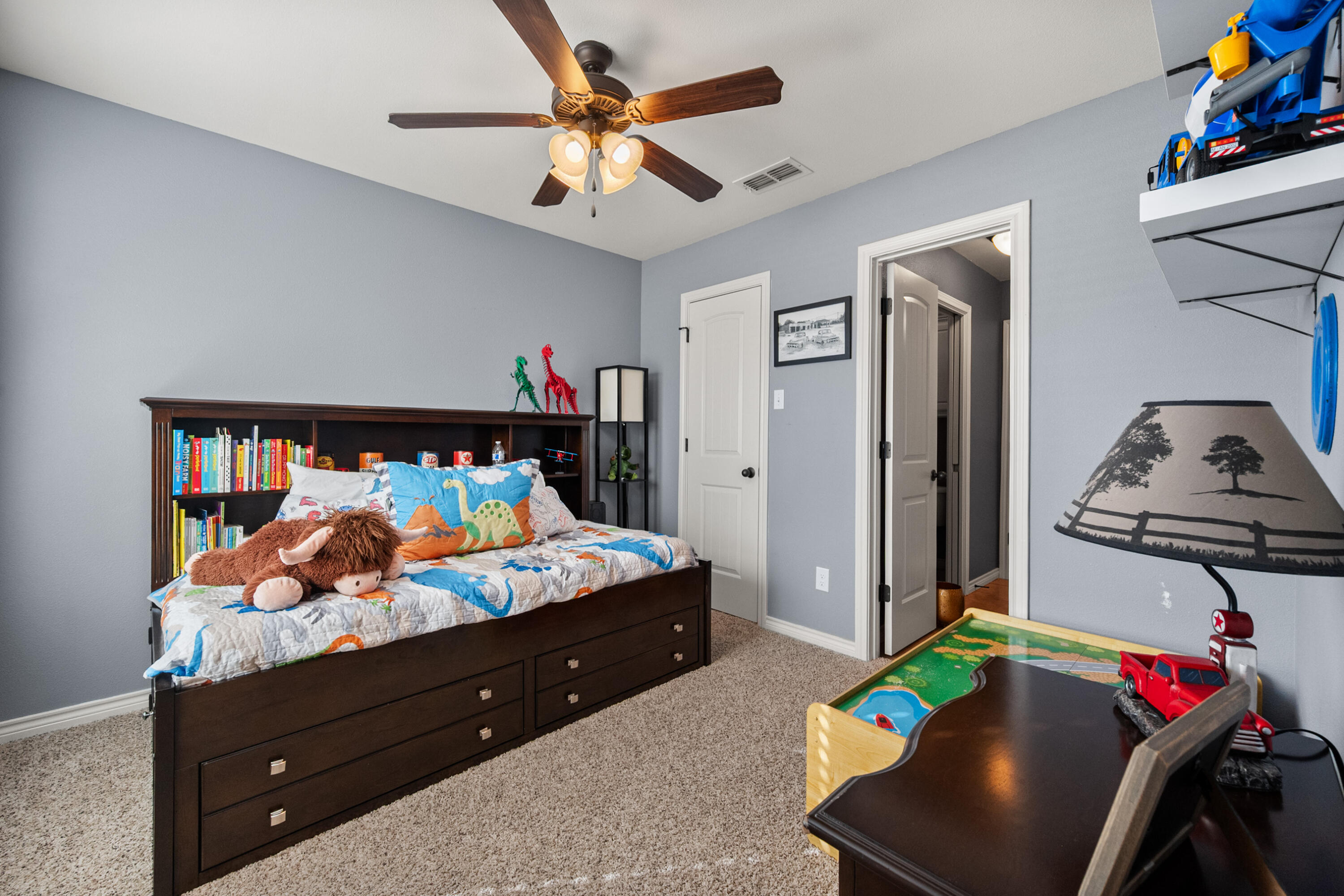 5908 104th Street Lubbock, TX 79424 - Photo 22 of 33 a bed room with a bed and a night stand