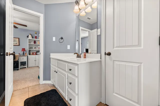 a bathroom with a double vanity sink and a mirror