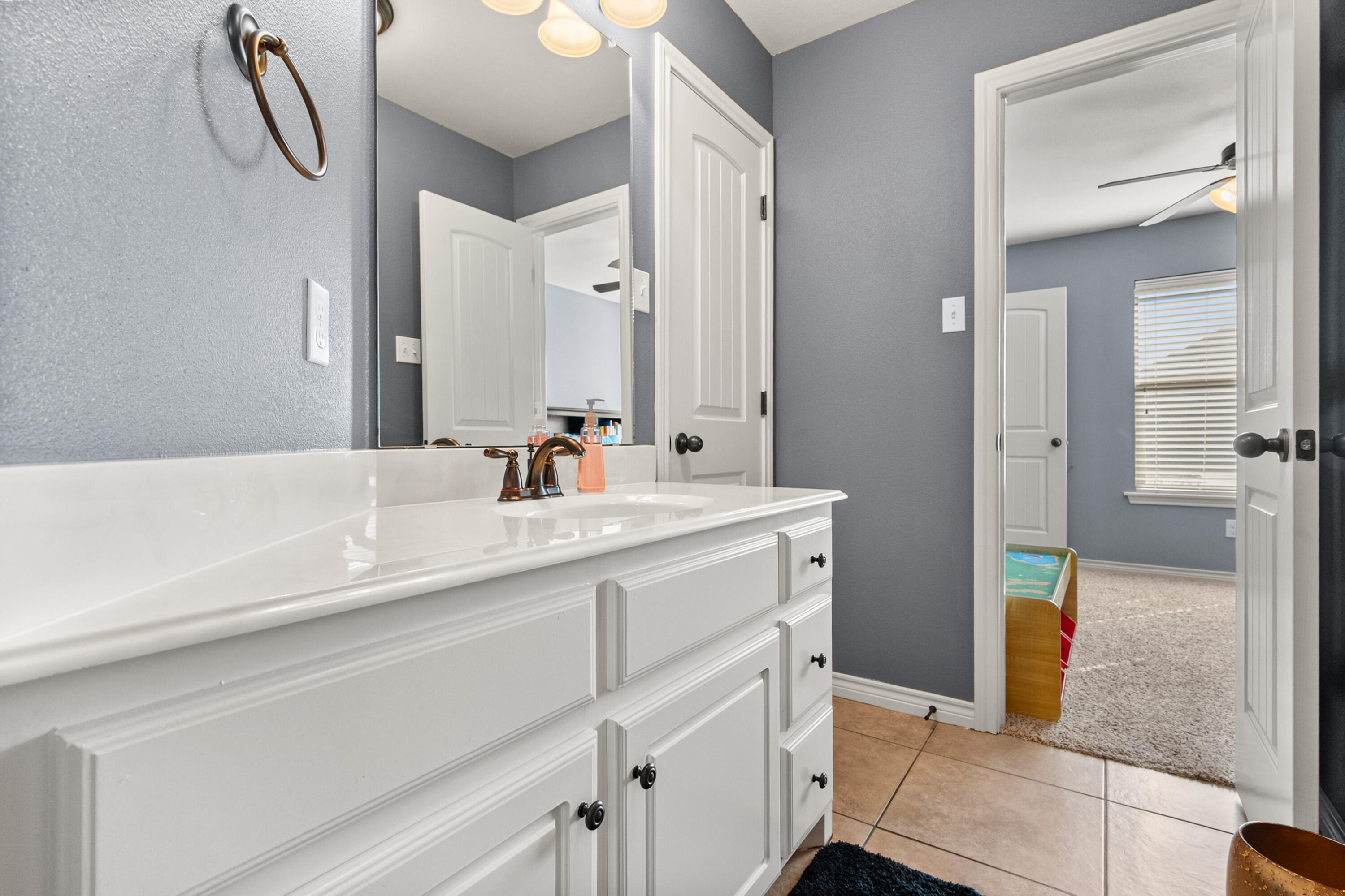 5908 104th Street Lubbock, TX 79424 - Photo 26 of 33 a bathroom with a sink a mirror and a shower