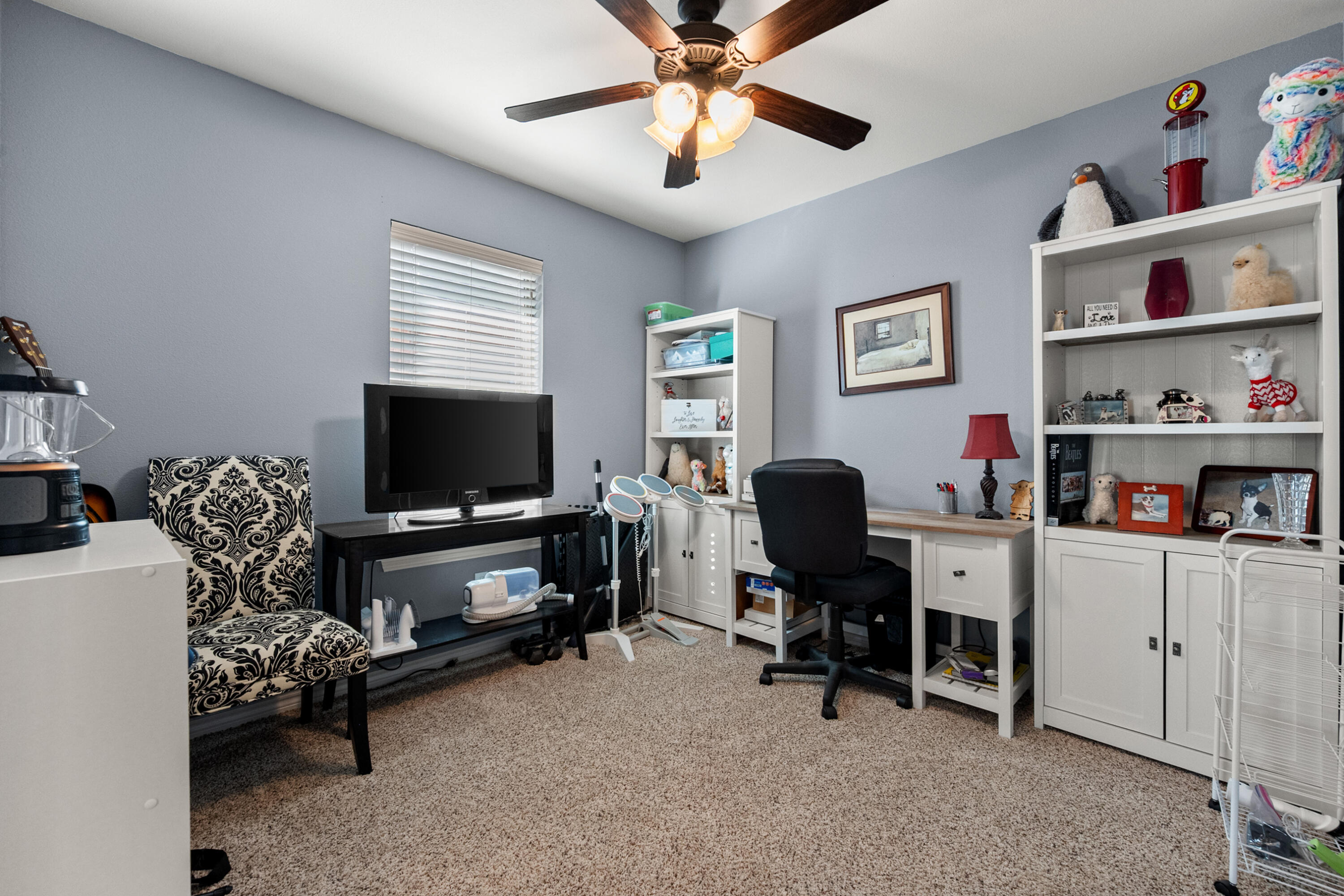 5908 104th Street Lubbock, TX 79424 - Photo 27 of 33 a living room with furniture and a flat screen tv