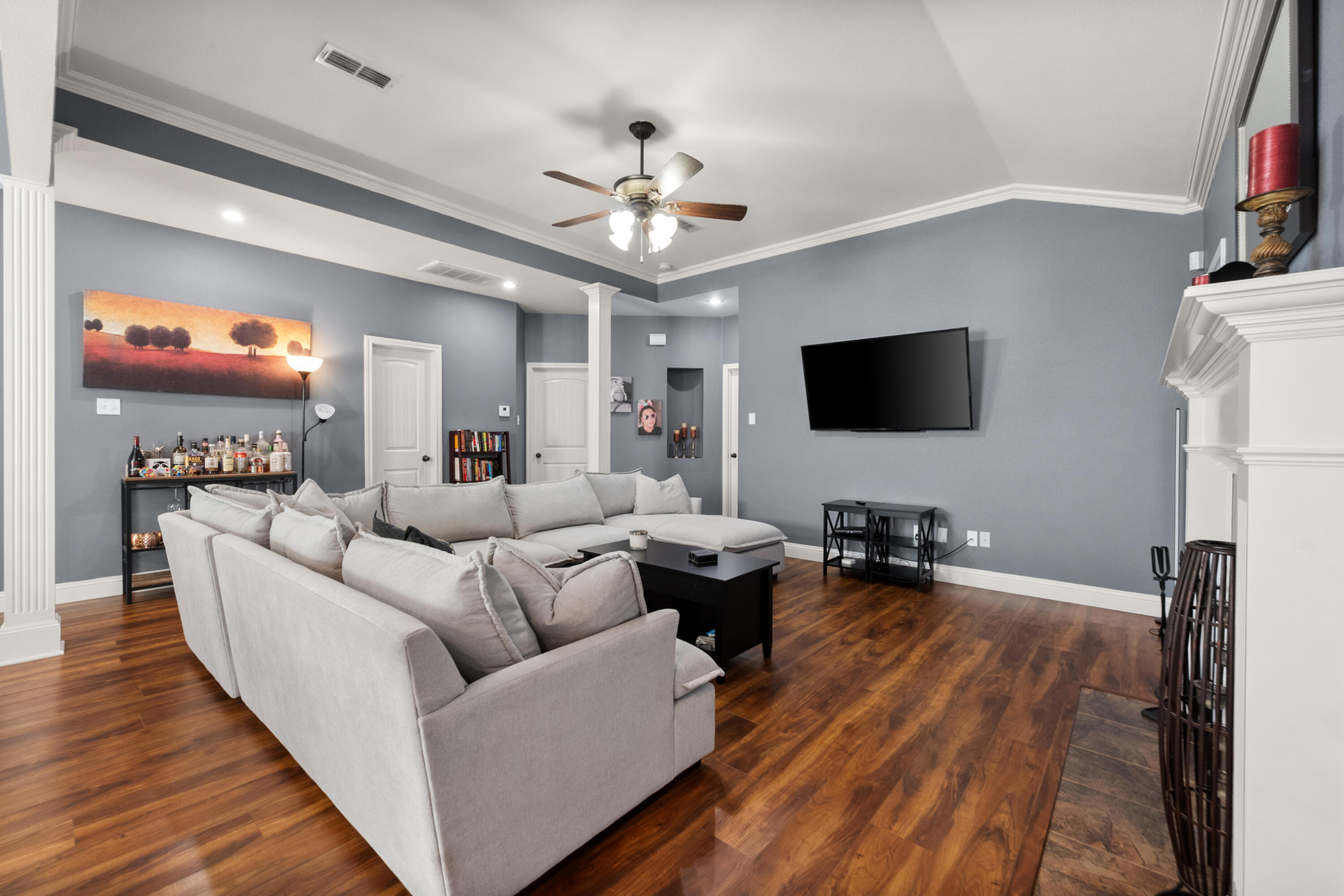5908 104th Street Lubbock, TX 79424 - Photo 5 of 33 a living room with furniture a flat screen tv and a fireplace