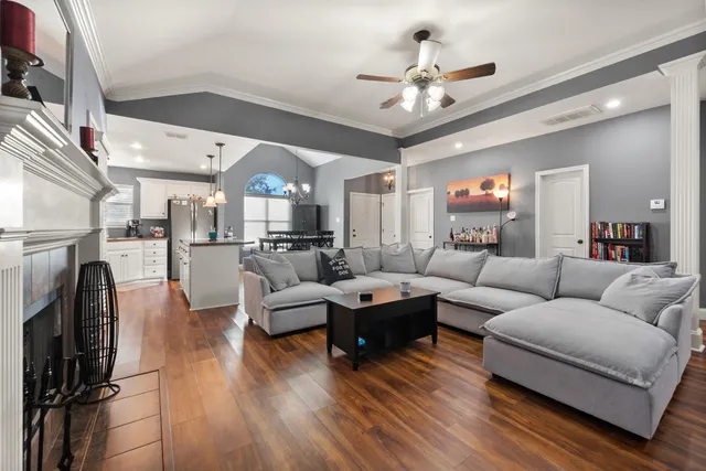 a living room with furniture fireplace and a chandelier