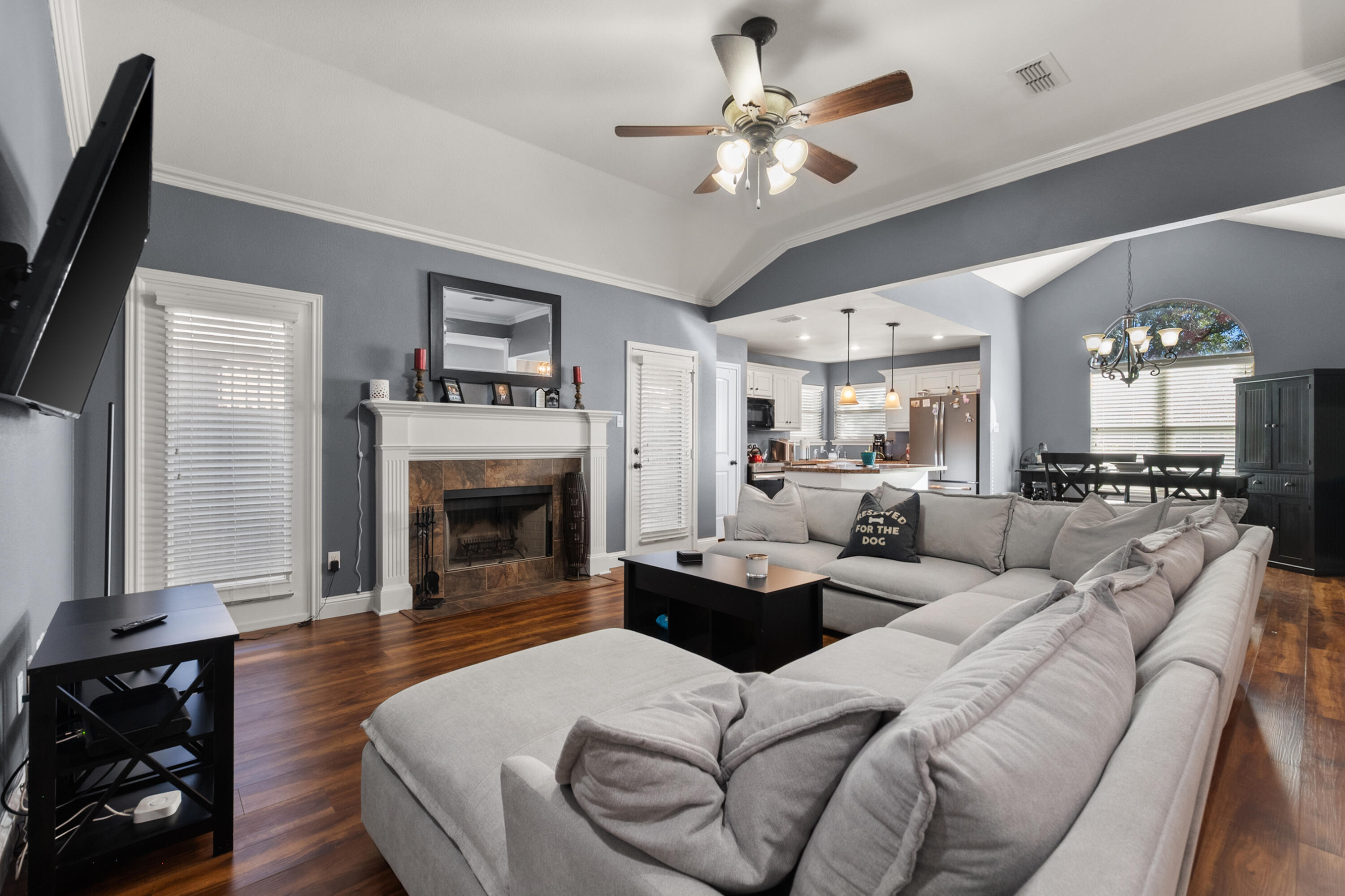 5908 104th Street Lubbock, TX 79424 - Photo 7 of 33 a living room with furniture a fireplace and a flat screen tv