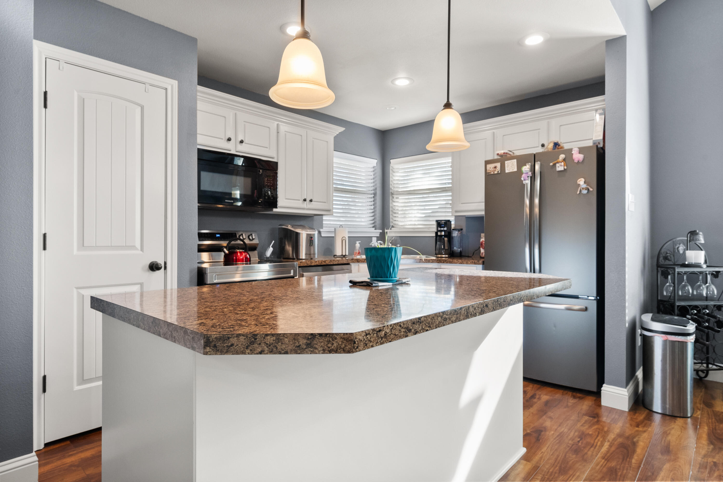 5908 104th Street Lubbock, TX 79424 - Photo 10 of 33 a kitchen with stainless steel appliances granite countertop a sink a refrigerator and a stove