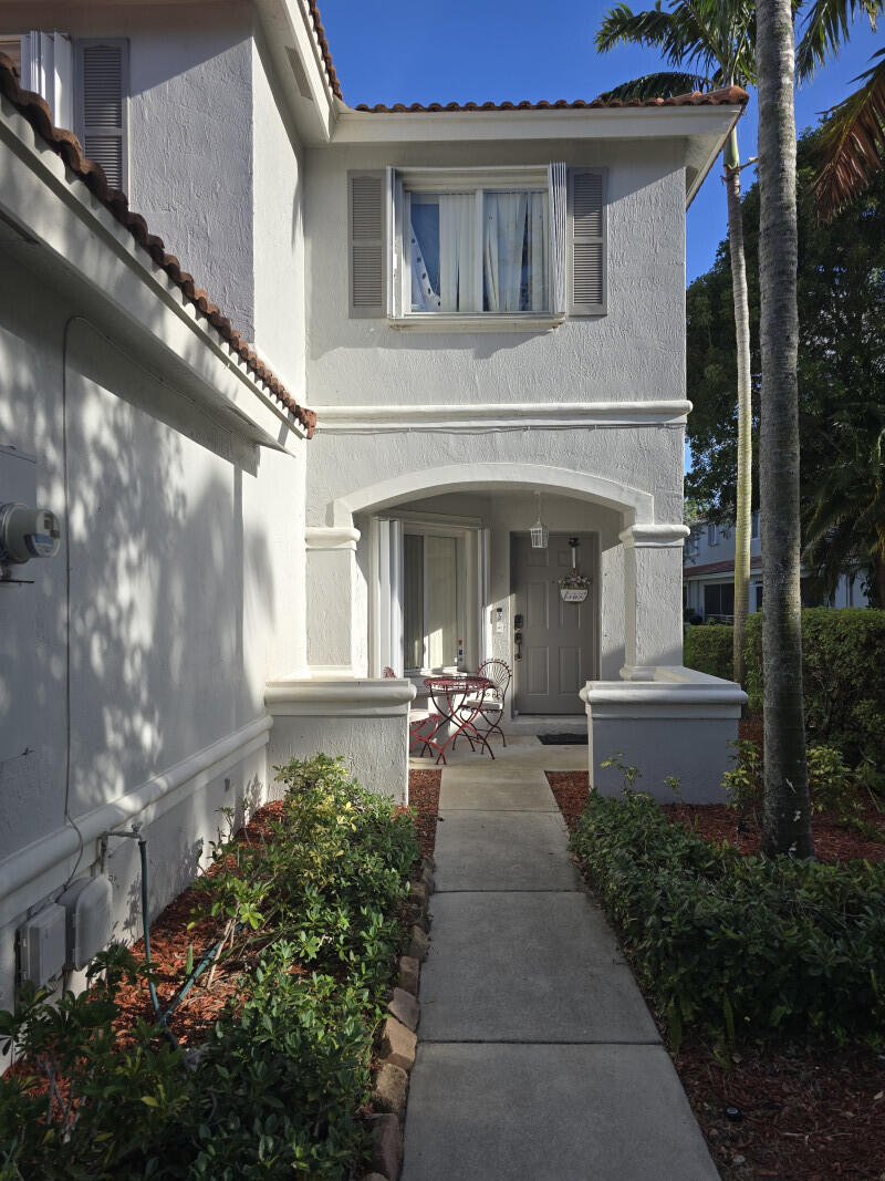 6511 Sandy Bank Terrace Riviera Beach, FL 33407 - Photo 1 of 12 a front view of a house with plants and outdoor seating