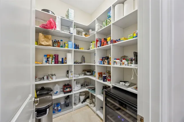 a spacious bathroom with a granite countertop sink a toilet a mirror and shower