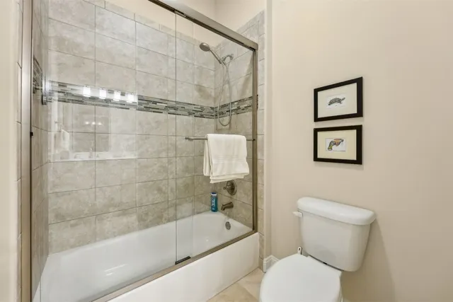 a bathroom with a granite countertop sink a mirror and a picture on the wall