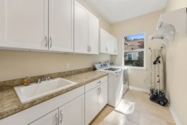 a view of backyard with potted plants and large tree