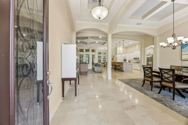 a view of a dining room with furniture and a chandelier