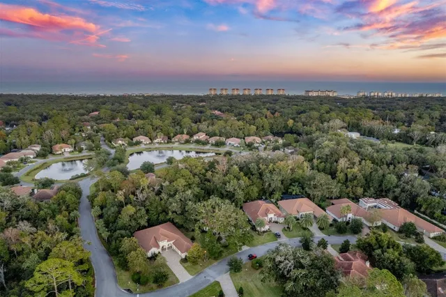 an aerial view of a house with garden space lake view and mountain view in back