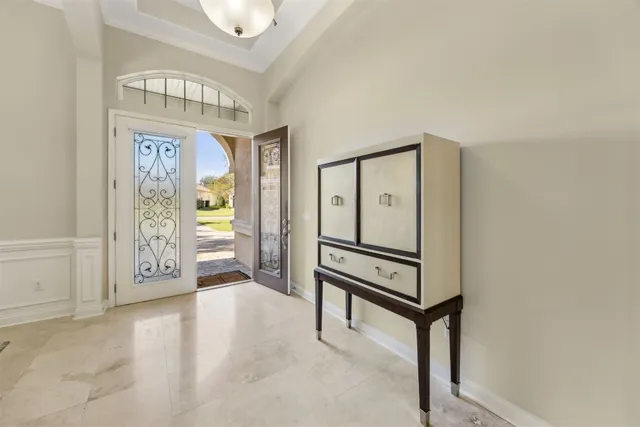 a view of a dining room with furniture and a chandelier