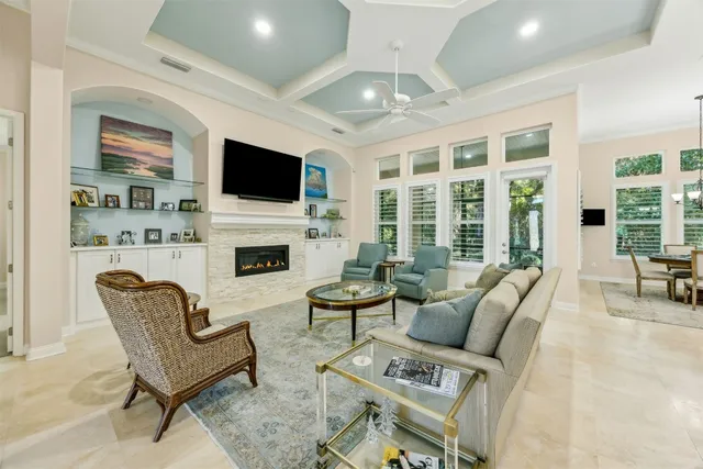 a living room with furniture a fireplace and a flat screen tv