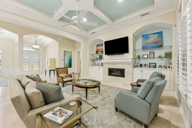 a living room with furniture flat screen tv and a fireplace