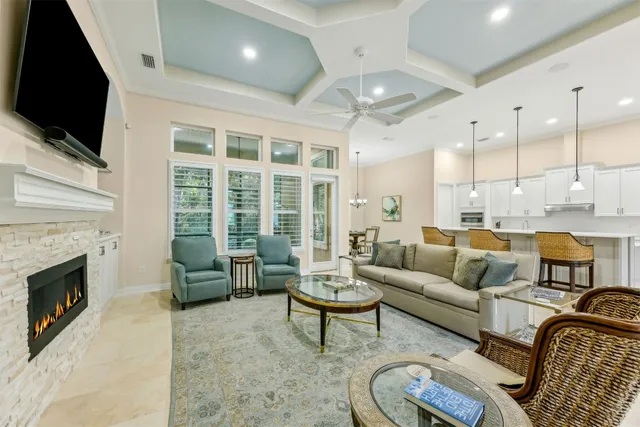 a kitchen with stainless steel appliances granite countertop table chairs sink refrigerator and cabinets