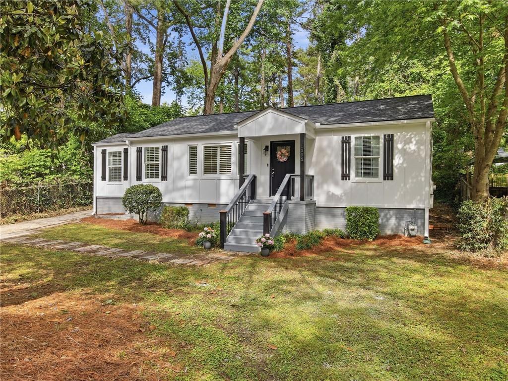 1222 Elizabeth Avenue Southwest Atlanta, GA 30310 - Photo 1 of 46 a front view of a house with a yard tree and outdoor seating