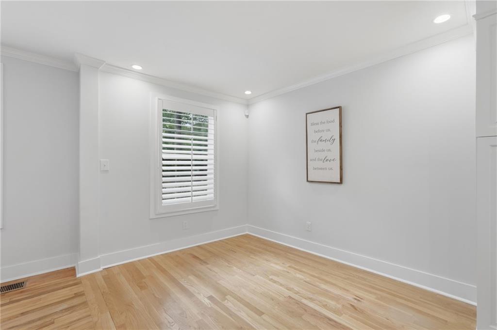 1222 Elizabeth Avenue Southwest Atlanta, GA 30310 - Photo 14 of 46 a view of empty room with wooden floor and fan