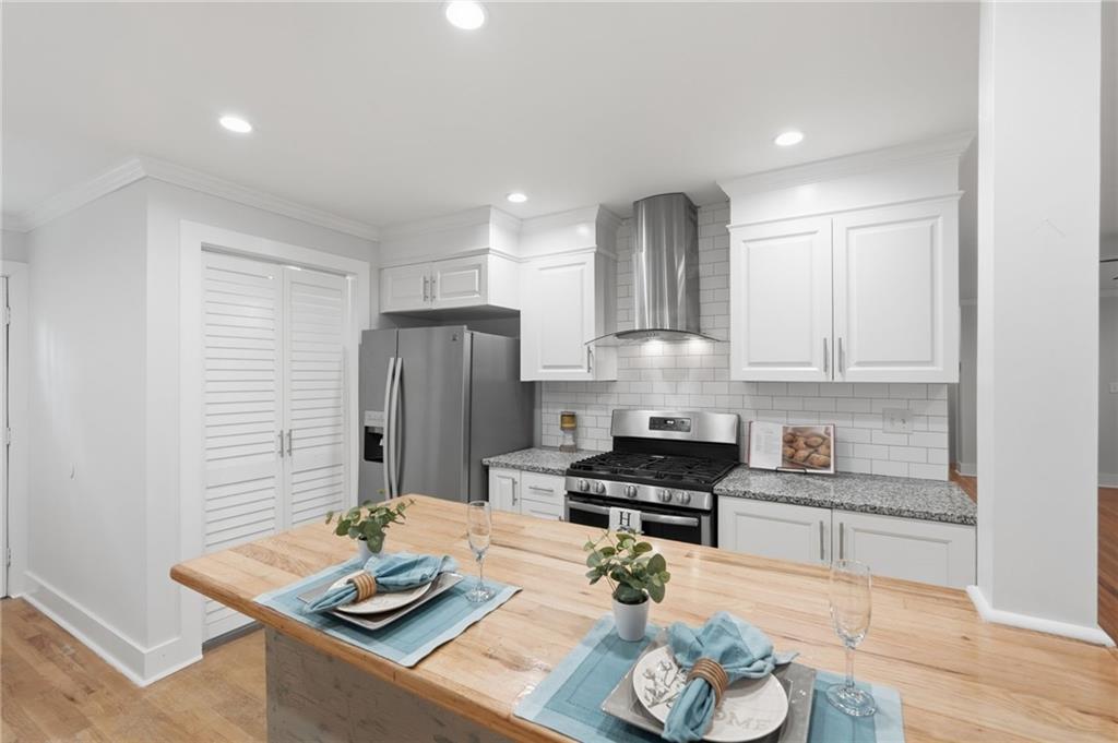 1222 Elizabeth Avenue Southwest Atlanta, GA 30310 - Photo 23 of 46 a kitchen with stainless steel appliances kitchen island granite countertop a sink refrigerator and stove