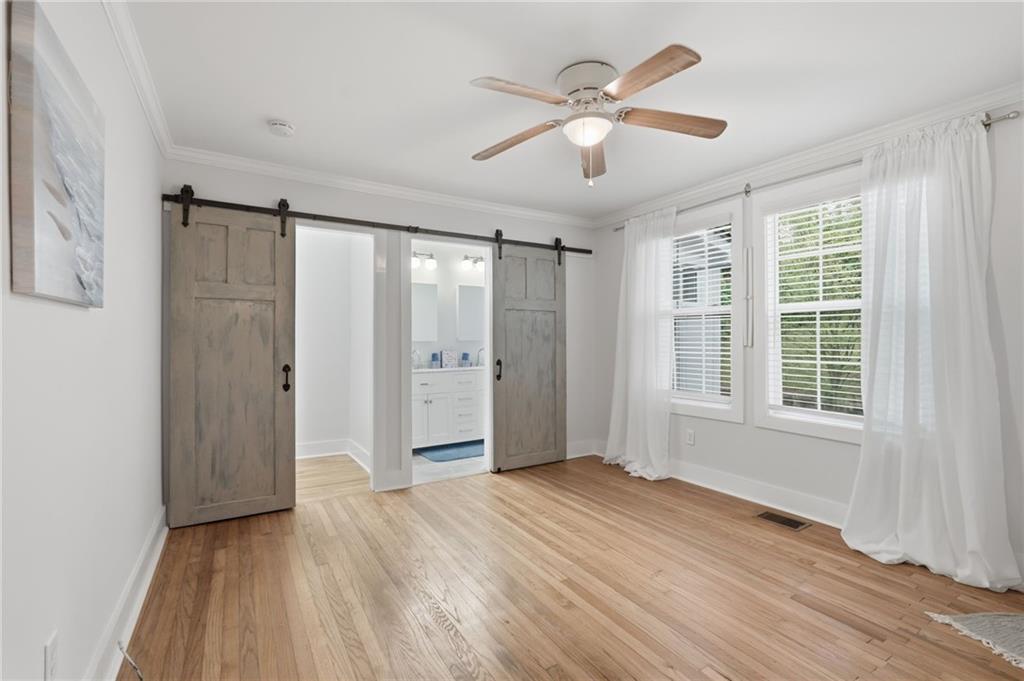 1222 Elizabeth Avenue Southwest Atlanta, GA 30310 - Photo 24 of 46 an empty room with wooden floor and windows