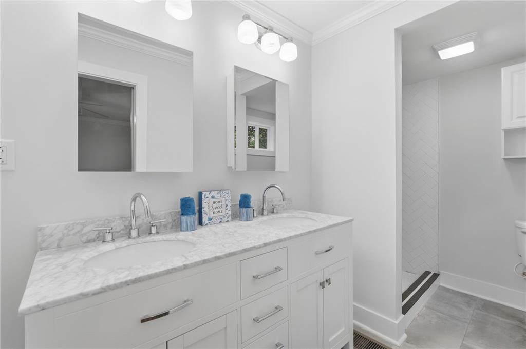 1222 Elizabeth Avenue Southwest Atlanta, GA 30310 - Photo 28 of 46 a bathroom with a granite countertop sink double and mirror