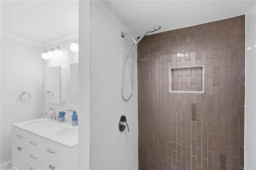 1222 Elizabeth Avenue Southwest Atlanta, GA 30310 - Photo 29 of 46 a bathroom with a sink a mirror and shower