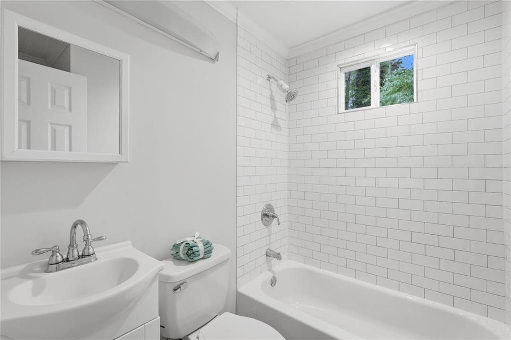 1222 Elizabeth Avenue Southwest Atlanta, GA 30310 - Photo 33 of 46 a bathroom with a bathtub sink vanity mirror and toilet