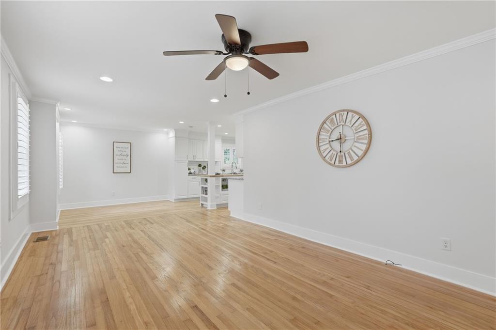 1222 Elizabeth Avenue Southwest Atlanta, GA 30310 - Photo 8 of 46 a view of a room with wooden floor and a ceiling fan