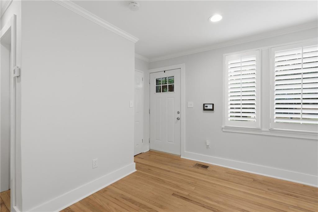 1222 Elizabeth Avenue Southwest Atlanta, GA 30310 - Photo 9 of 46 an empty room with wooden floor and windows