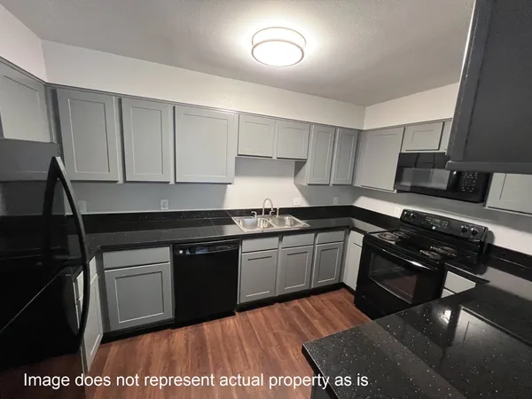 a kitchen with stainless steel appliances granite countertop a sink and a stove