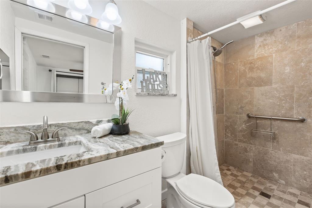 2462 Fort Lane Road Geneva, FL 32732 - Photo 18 of 31 a bathroom with a granite countertop sink toilet and shower