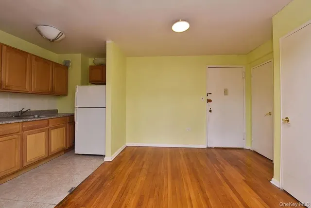 a view of a kitchen with a sink and a refrigerator