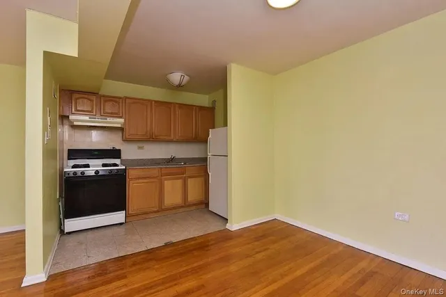 a kitchen with a wooden floor and a stove top oven